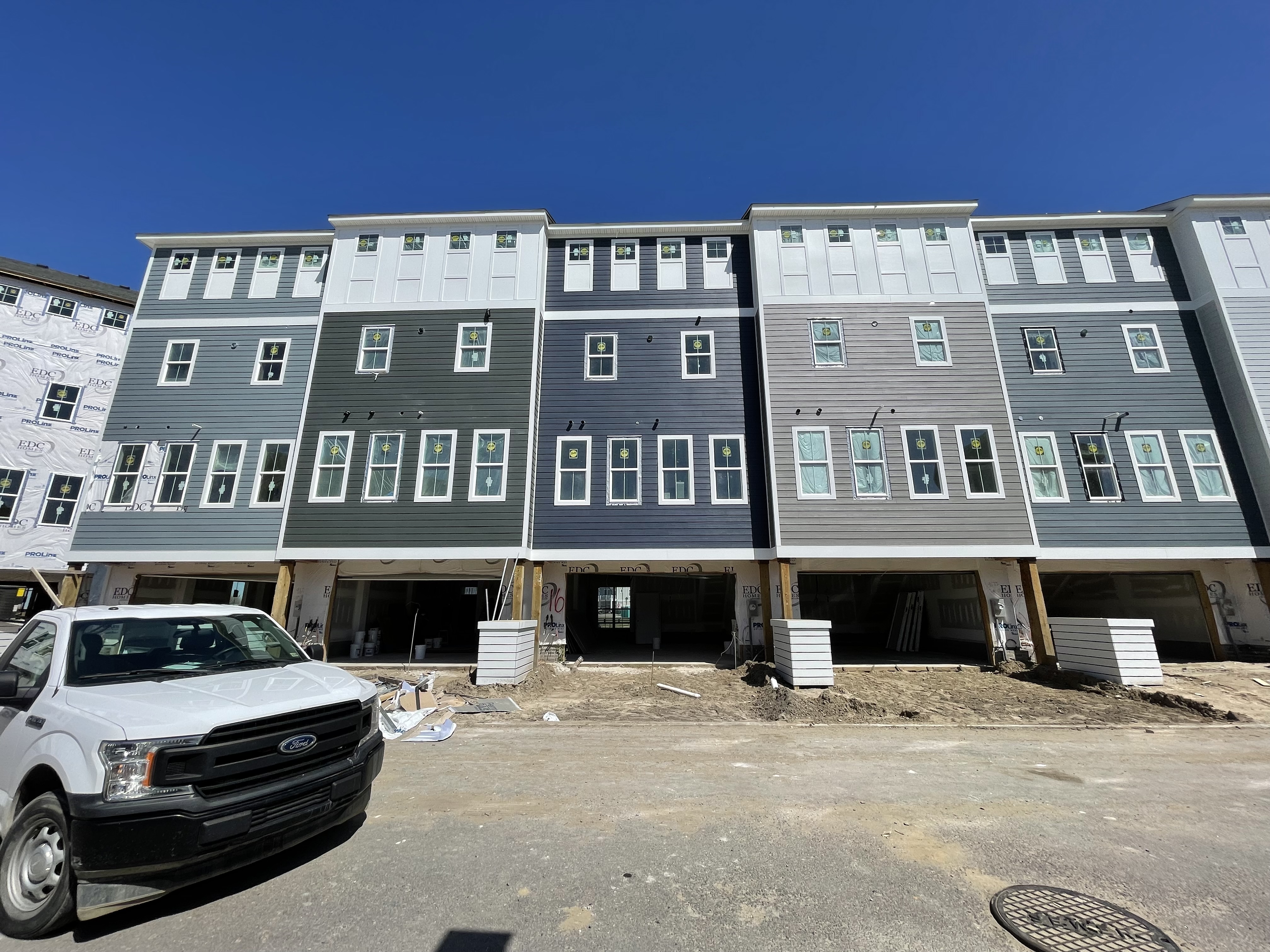 Row of elevated coastal homes with garage-level entries