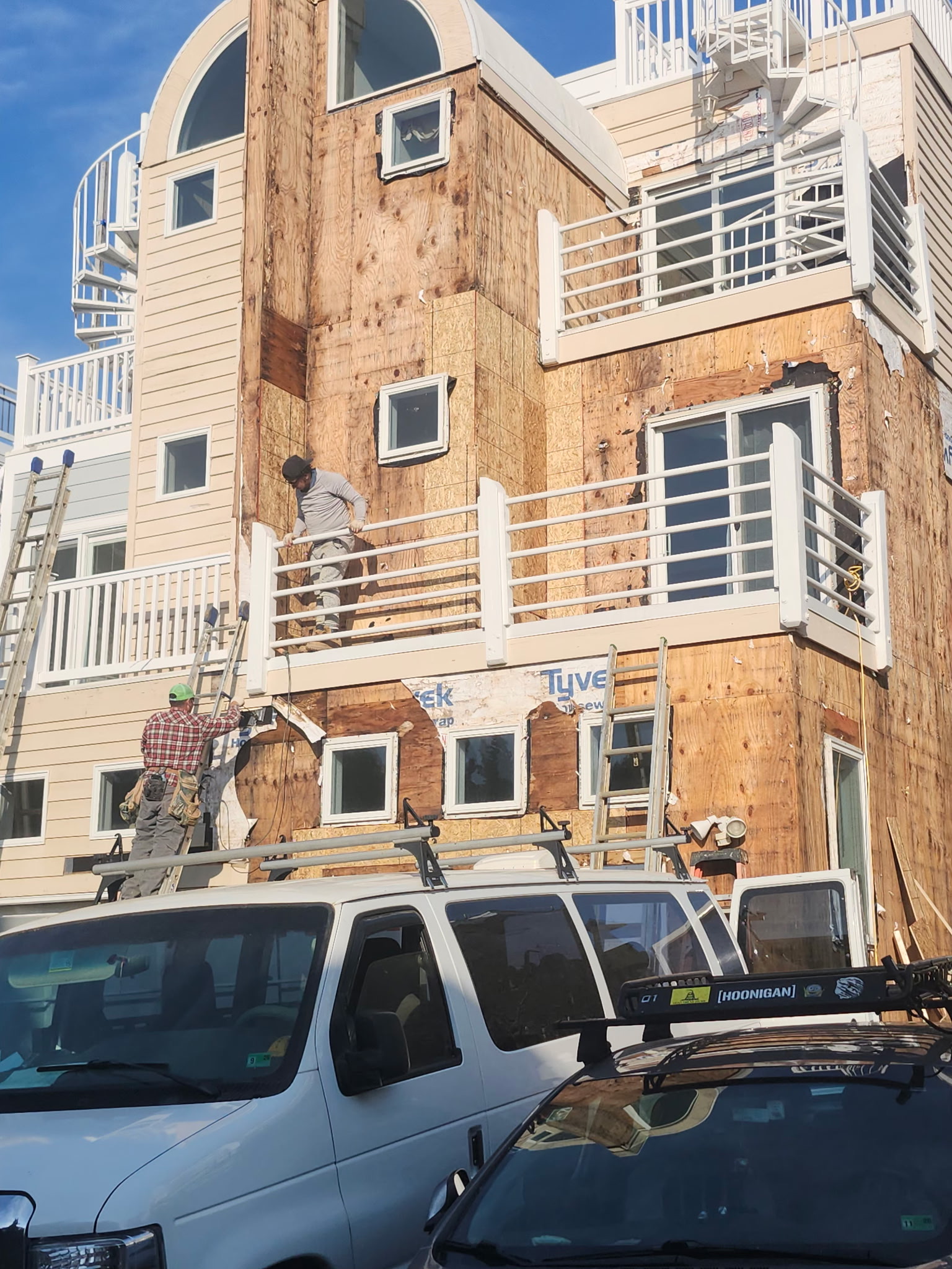 Crew repairing a coastal home exterior